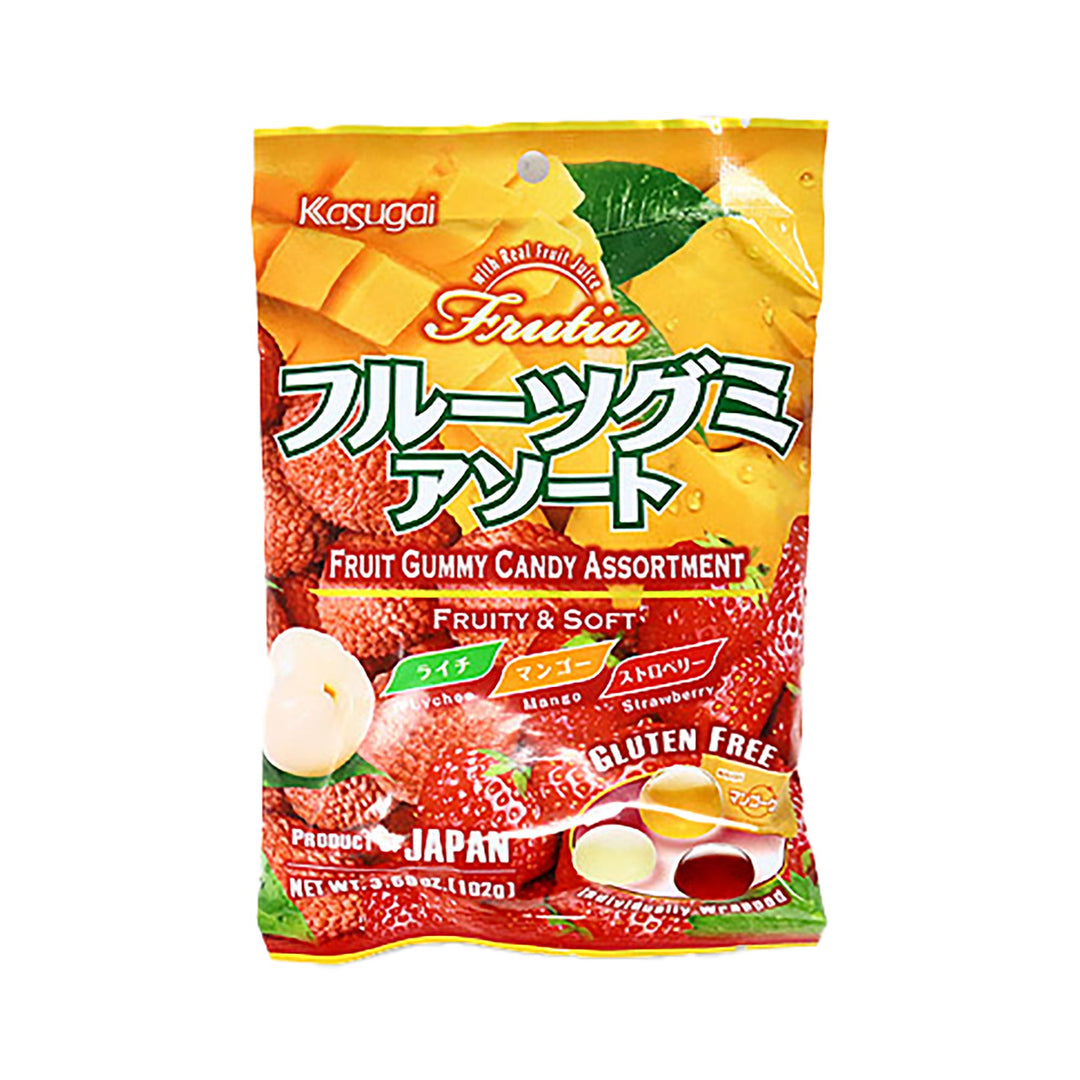 A vibrant package of Kasugai Fruitia Gummy Assort features illustrations of lychee, mango, and strawberry. The packaging emphasizes the "Fruity & Soft" texture and "Gluten Free" quality. Experience the lively fruity flavors from Japan.