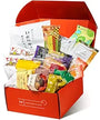 An open Bokksu Snack Box: Seasons of Japan (FBM) displays a vibrant assortment of Japanese snacks in colorful packaging, all neatly arranged upright and slightly overlapping inside the box. thumbnail 6
