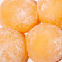 Close-up of Kubota Mikan Orange 4 Pack Daifuku Mochi ice cream with a dusting of powder on a white background. thumbnail 3