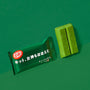 A Matcha Moments Box sits on a green surface, with Japanese text visible, next to two unwrapped matcha treats against a matching background. thumbnail 20