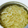 A metal bowl holds thinly sliced ginger soaking in water, ready to be paired with Bokksu Tinned Shirasu Anchovies with Yuzu Pepper for a flavorful touch. thumbnail 5