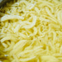 Bokksu Tinned Shirasu Anchovies with Yuzu Pepper features small white shirasu anchovies in yellowish yuzu pepper-infused oil, with visible bubbles and floating particles. thumbnail 6