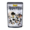 Packaging of HBAF Korean Style Almonds: Black Sesame featuring playful illustrations of almonds and characters in a black and white theme, highlighting the black sesame flavoring with text in English and Korean.