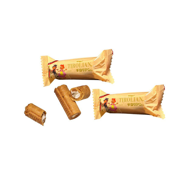 Two wrapped Tirolian Dupai rolled wafer snacks and three unwrapped pieces—one showing white cream filling—are displayed on a white background. Enjoy these Japanese treats, featured in the Japan Crate Medium Crate, for a delightful snack experience.