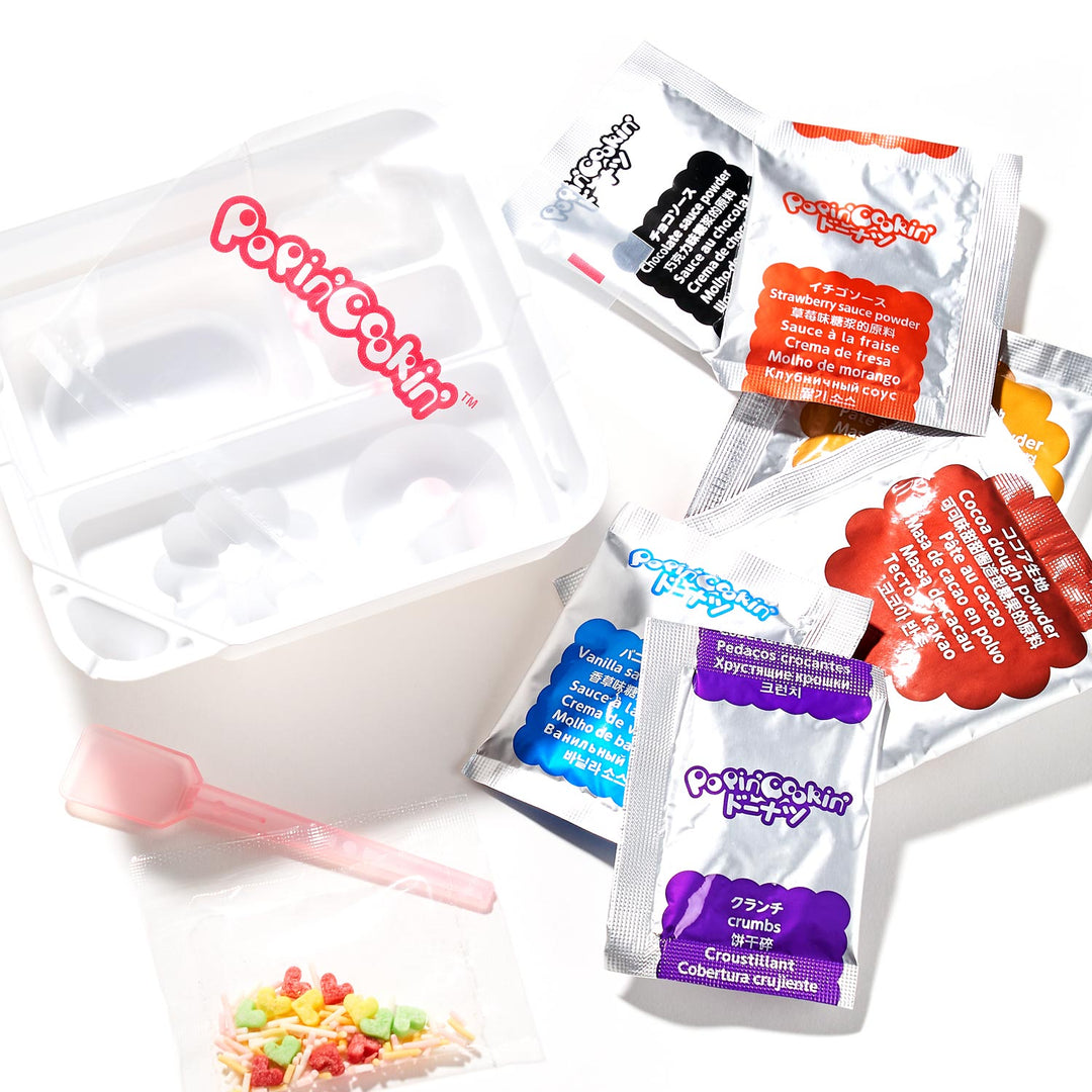 The Bokksu Market DIY Candy Kit Pack (6-Pack) comes with packets of flavored powders, a plastic tray, a spoon, and candy decorations to make your own homemade candies.