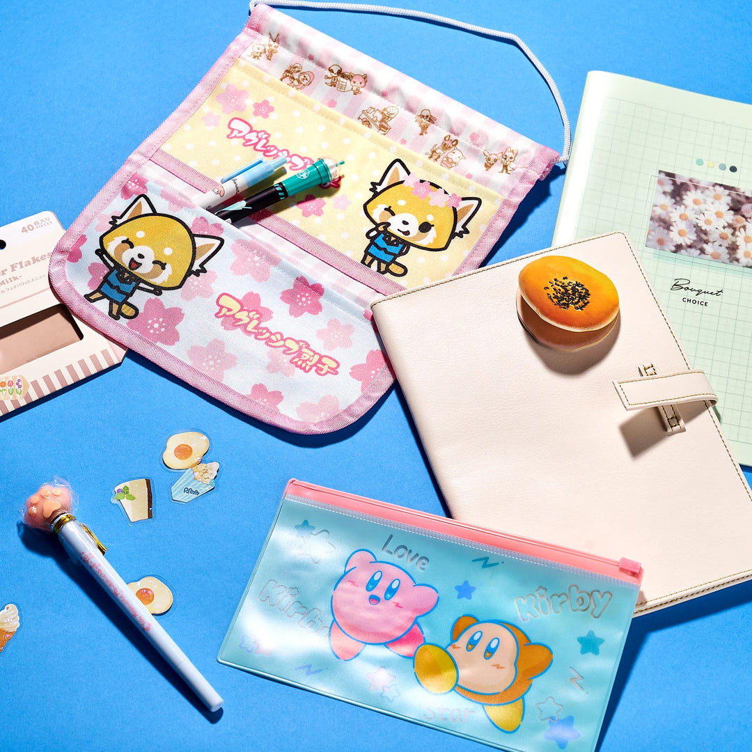 Explore Bokksu's Kawaii Gift Pack, featuring a vibrant stationery set with cartoon designs: pink floral pouch, notebooks, pens, adorable stickers, and a small coin pouch. Everything is beautifully displayed on a blue background.