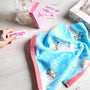A hand holds a pink bandage near cute bandages, a blue cat towel, tissue box, and clear container—perfect for pairing with your Kawaii Gift Pack - Stationery Surprises &amp; Japanese Chocolate Treats on a marble surface. thumbnail 2