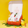 An open Japanese Fruits Gummy Box displays a colorful assortment of fruit gummies, with additional gummies and whole lemons scattered around on a vibrant yellow background. thumbnail 1