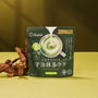 A green Matcha Moments Box, ideal for matcha treats, stands upright on a yellow-green surface with driftwood to the left and a cup of matcha latte shown on the packaging. thumbnail 17