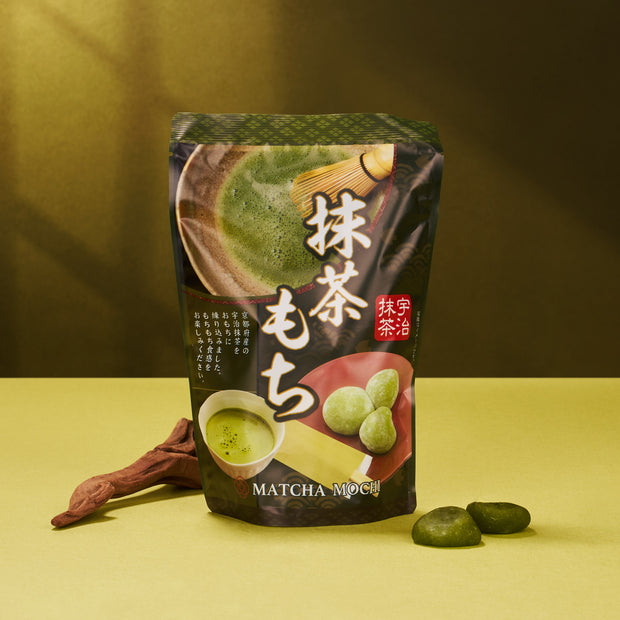 The Matcha Moments Box features Japanese green tea mochi treats, beautifully displayed against a yellow and green background.
