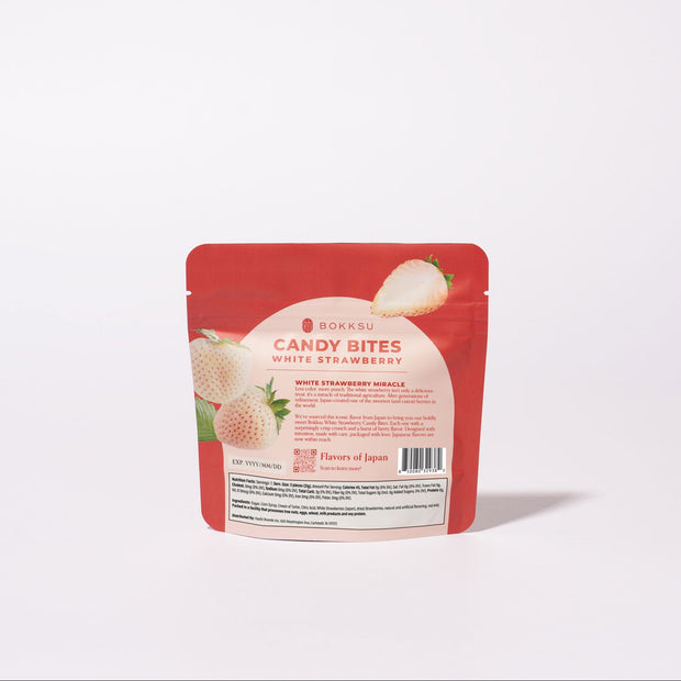 A red and white package labeled "White Strawberry Japanese Candy Bites 0.75oz" displays images of Japanese white strawberry, highlighting this rare fruit snack against a plain white background.