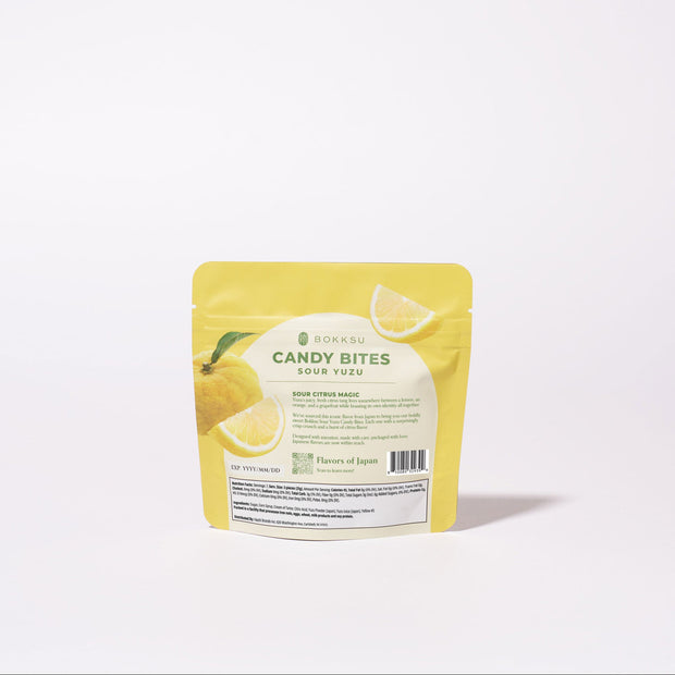 A yellow package of Sour Yuzu Japanese Candy Bites 0.75oz stands upright on a white background, with lemon slice images displayed on the packaging.