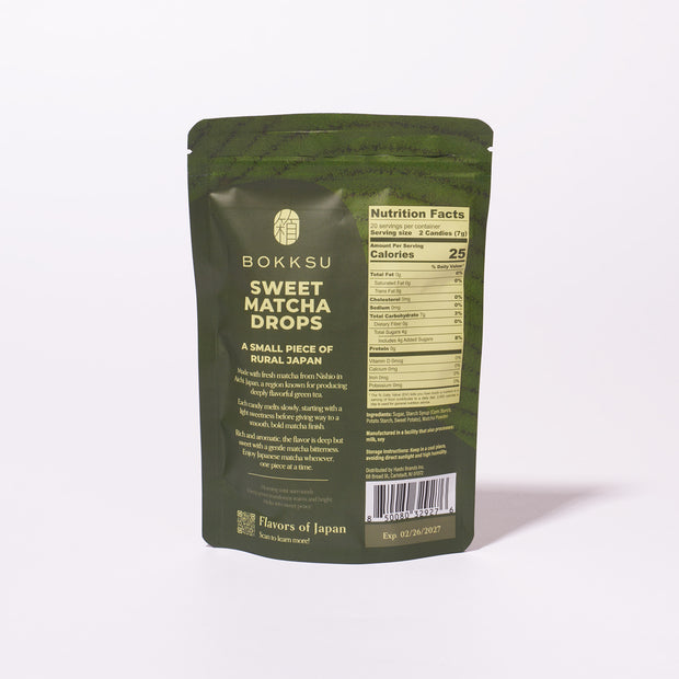 A green resealable bag labeled "Bokksu Sweet Matcha Drops" contains Japanese matcha candy, with nutrition facts and description on the back. Expiration date: 02/29/2027.