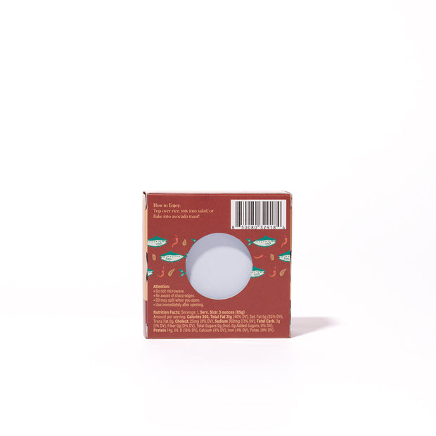 A red Bokksu Spicy Japanese Sardines box with fish and shrimp illustrations, a barcode, a round window displaying the sardines, plus text featuring instructions and nutritional info.