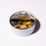 An open can of Bokksu Japanese Mackerel in olive oil, showing pieces of mackerel and yellow potatoes inside, sits on a white surface. thumbnail 5