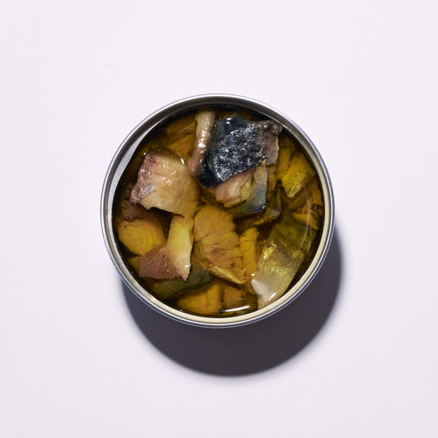 A tin of Bokksu Japanese Mackerel in oil, filled with chunky fish pieces, is shown open from above on a plain white background.