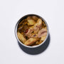 An open tin of Bokksu Spicy Japanese Sardines in olive oil, viewed from above on a plain white surface. thumbnail 5