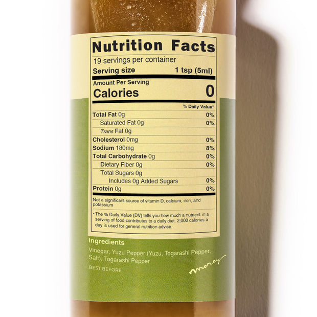 A close-up of a nutrition facts label for Bokksu Yuzu Hot Sauce from Bokksu. Highlights include 0 calories, 180mg sodium, and 19 servings per container. Ingredients are Yuzu Pepper, Togarashi Pepper, and salt. This spicy and tangy mix makes it an excellent Tabasco alternative for those seeking something new.