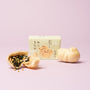 A yellow box adorned with cat illustrations—The Cat Lover’s Box—sits between two cat-shaped wafers (one open to reveal its seaweed and rice filling) against a pale pink background, making these Japanese cat-themed snacks irresistibly charming. thumbnail 5