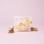 A cat-shaped cookie with yellow paws and Japanese text, packaged in clear wrapping and displayed on a light pink background beside two small wafer pieces—an ideal treat for The Cat Lover’s Box or anyone collecting Japanese cat-themed gifts. thumbnail 6
