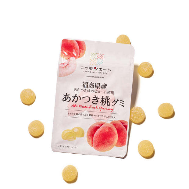 A bag of Premium Japanese Fresh Gummy Set (Plastic Bag) with Japanese text, surrounded by several round yellow premium gummies on a white background.