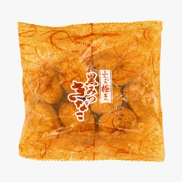 A sealed package of Doki Doki Snack Mix: Japan Mochi Puffs features orange wrapping with white Japanese text and contains round, brown mochi treats.