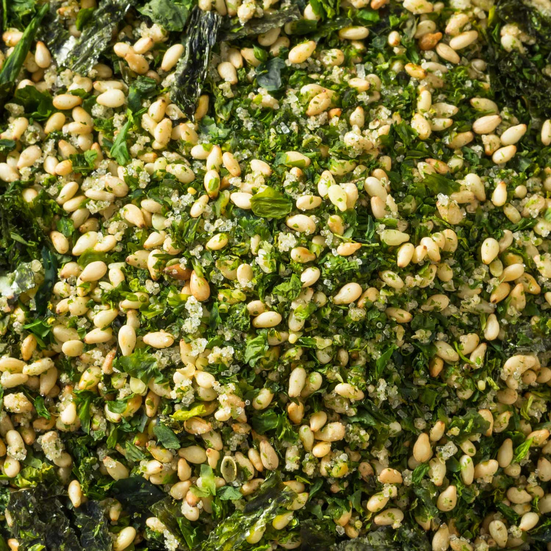 A close-up of seasoned rice mixed with greens and topped with toasted pine nuts, enhanced by a hint of umami-rich Ajishima Furikake Rice Seasoning: Wasabi.