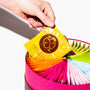A hand picks up a yellow Satsumarche tea bag from the Kagoshima Seicha Gift Box: Satsumarche Tea Bags (49 Pieces, 7 Flavors), which features colorful assorted packets arranged in a fan shape. thumbnail 3
