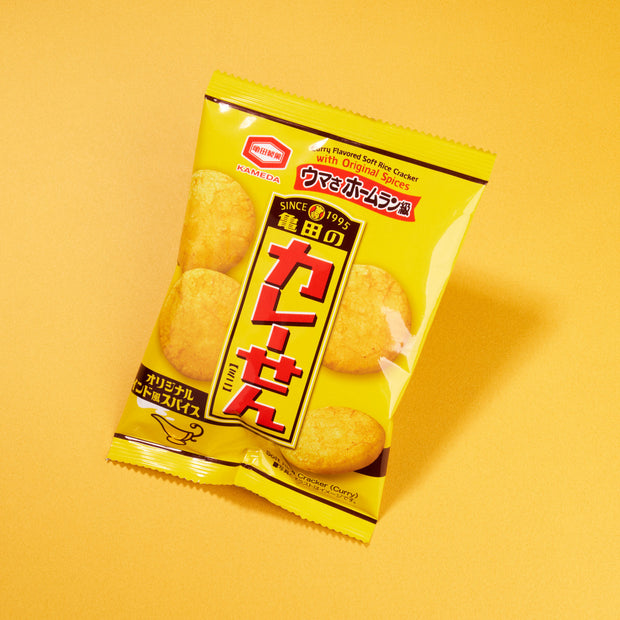 An upright yellow bag from April '26 Bokksu: Handpicked in Japan is displayed on a matching yellow background.