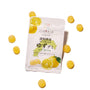 A white package of the Premium Japanese Fresh Gummy Box (Orange Box) is surrounded by several round, yellow gummies on a white background. thumbnail 8