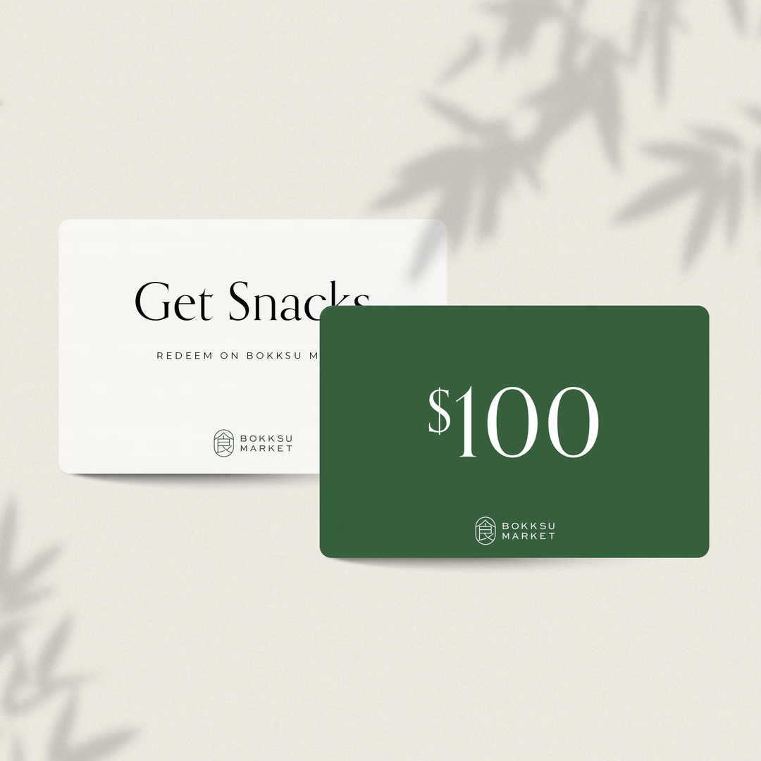 Get two Bokksu Digital Gift Cards: a white "Get Snacks" card and a green "$100" card from Bokksu Market. Perfect for exploring Asian groceries, these thoughtful presents can include a personalized message to complete the gift!.