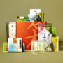 A neatly arranged selection of Japanese snacks and teas, including green tea treats, features colorful packages and The Japanese Tea Box, all displayed on a neutral background. thumbnail 1