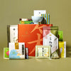 A neatly arranged selection of Japanese snacks and teas, including green tea treats, features colorful packages and The Japanese Tea Box, all displayed on a neutral background.