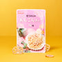 A pink and white package of Sokan lotus root chips is displayed upright on a yellow surface, with some chips beside the bag—one of the tasty treats included in The Japanese Savory Snack Box. thumbnail 9