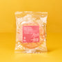 A packaged Soka Senbei: Ume Zarame rice cracker from The Japanese Savory Snack Box rests on a yellow background, featuring a pink label with product and collaboration details. thumbnail 10