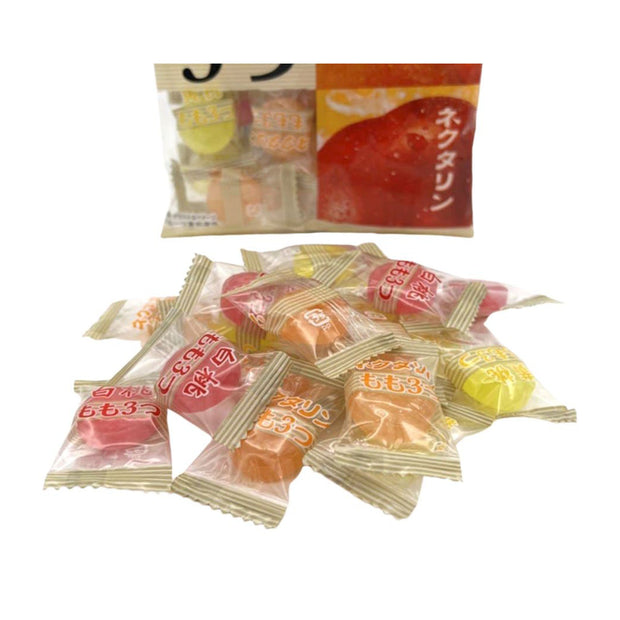 Individually wrapped Pine Candy: 3 Apple Flavors, including Fuji apple, are displayed in front of a partially visible package with Japanese text and fruit images.