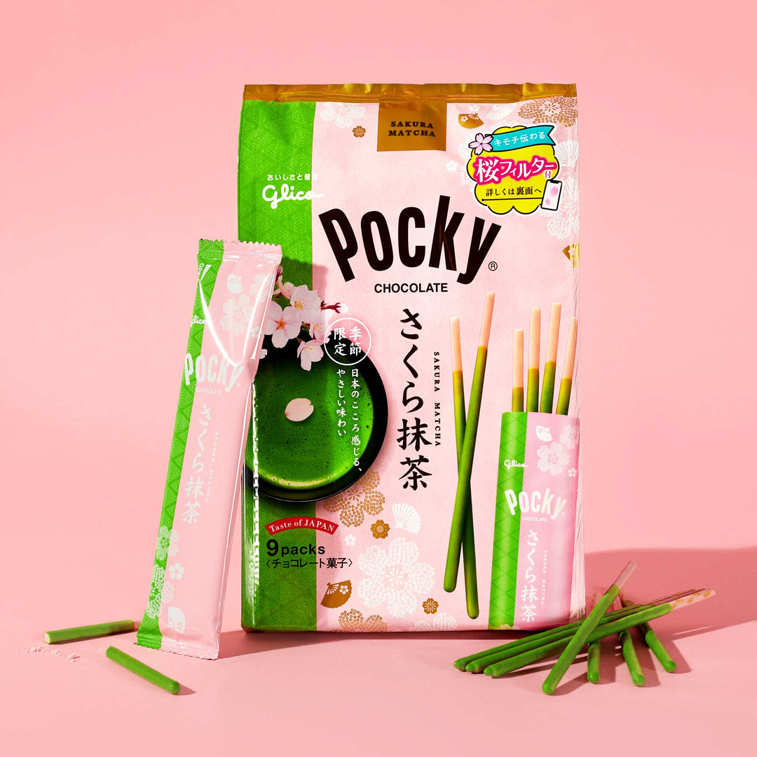 Package of Glico Pocky: Cherry Blossom Matcha showcasing green-coated biscuit sticks reminiscent of cherry blossoms, set against a pink background. Enjoy the delightful combination crafted by Glico.