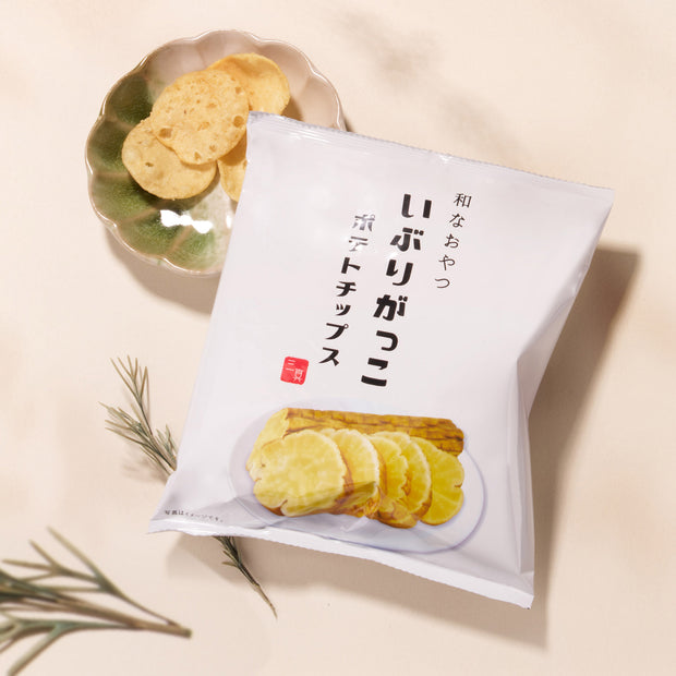 The Bokksu Snack Box: Seasons of Japan features authentic Japanese potato chips, artfully presented with sliced and loose chips plus herbs beside the package—a delicious taste of Japan for snack enthusiasts.