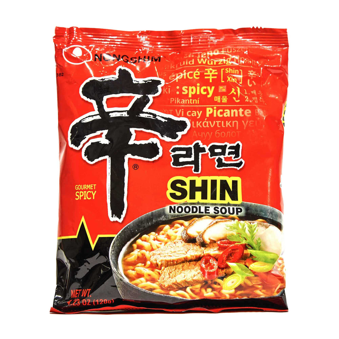 A package of Nongshim Shin Ramyun Spicy Ramen showcases striking red packaging, with a depiction of instant ramyun noodles prominently displayed on the front, complemented by a savory beef and vegetable-based broth.