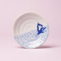 Small white plate featuring a blue geometric pattern and a cute blue cartoon cat design, perfect for serving up cat-themed snacks or as an adorable addition to The Cat Lover’s Box, all set against a light pink background. thumbnail 3