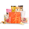 An assortment of Japanese snacks and instant soups surrounds an orange box labeled 
