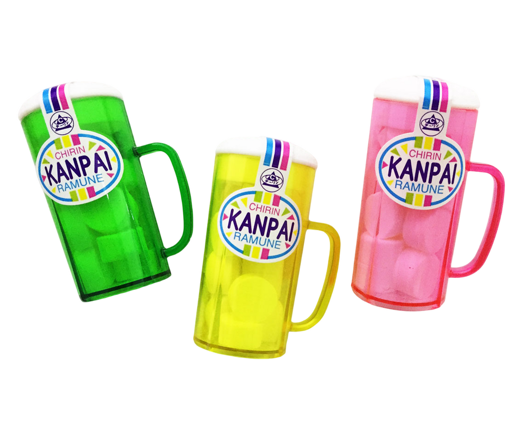 The Chirin Cup Kanpai Candy: Ramune by Sugoi Mart Retail features three vibrant soda bottles shaped like mugs, available in green, yellow, and pink. Each bottle boasts a striped label and handle. These candies offer a fizzy delight reminiscent of Japanese confections that dances on the tongue.