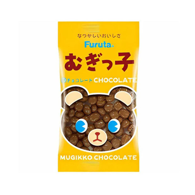 A yellow bag labeled "Furuta Mugikko Chocolate" features small bear-shaped chocolate pieces and a cute bear face design on the packaging, making it a delightful treat to include in the Dagashi Snack Crate - 30-Piece Japanese Snack Variety Box with Candy, Chocolate, Cookies, Mochi & Ramune Treats—perfect for fans of authentic Japanese snacks.